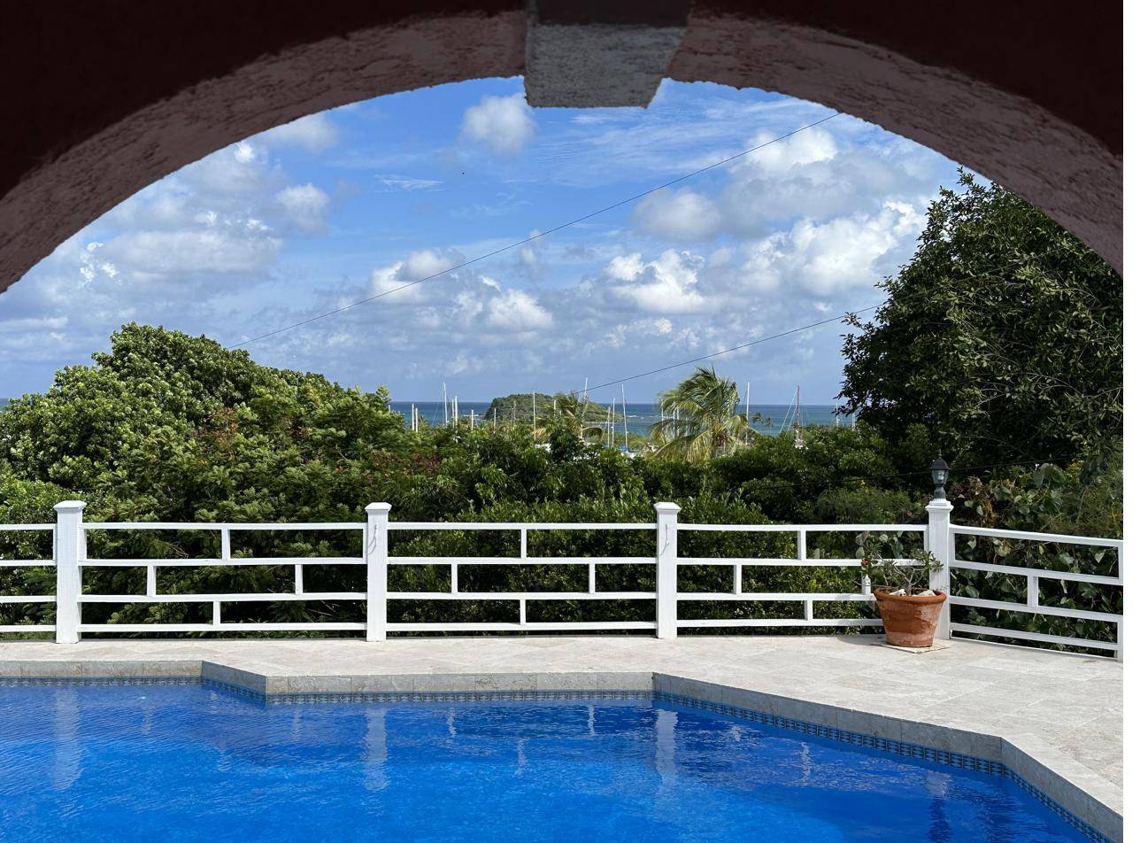 View through Casa Gibo's pool arch to Green Cay Marina